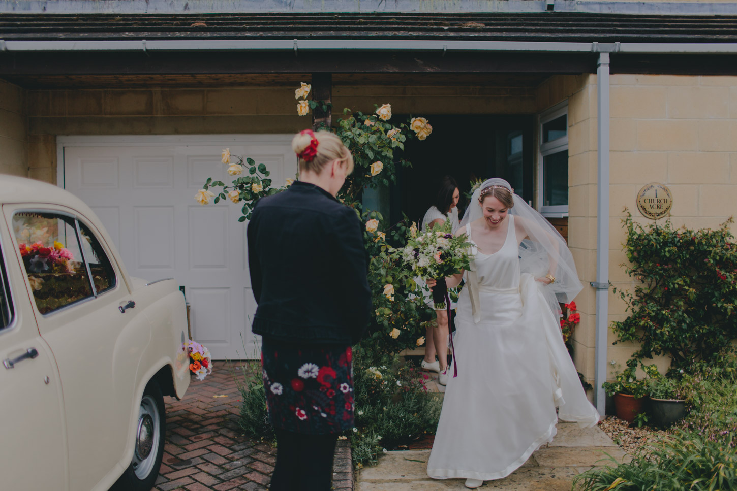 Bride and father leaving family home on wedding day