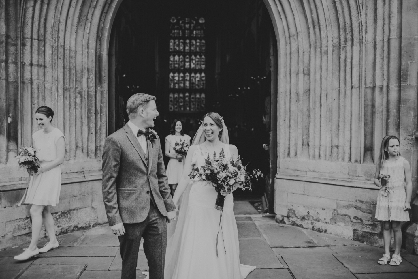 Bride and Groom outside of Bath Abbey laughing