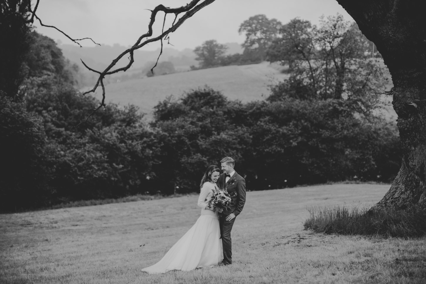 Black and White image of Bride and Groom under tree by Tori Hancock Photography