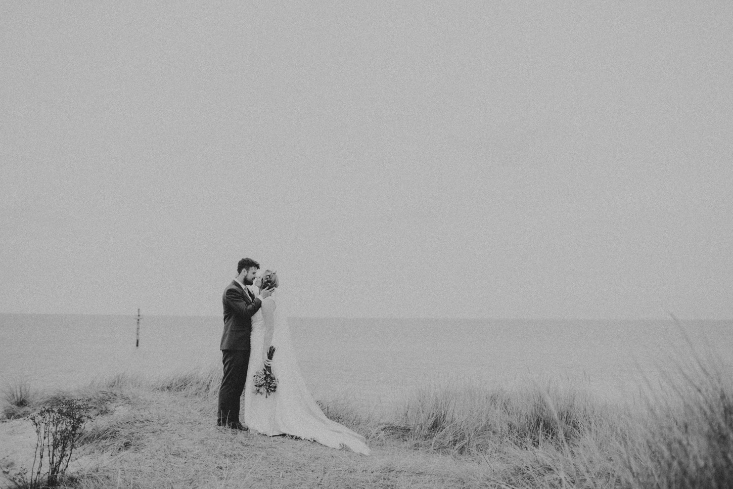 black and white image of Bride and Groom in Dunes by Tori Hancock Photography
