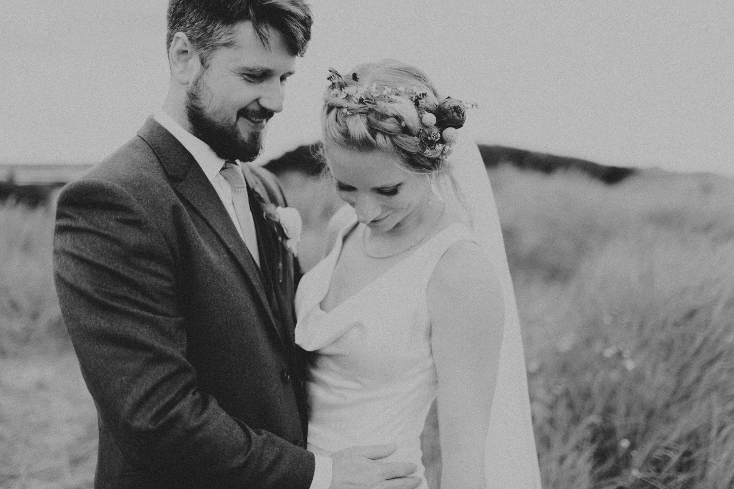 black and white image of bride and groom in dunes