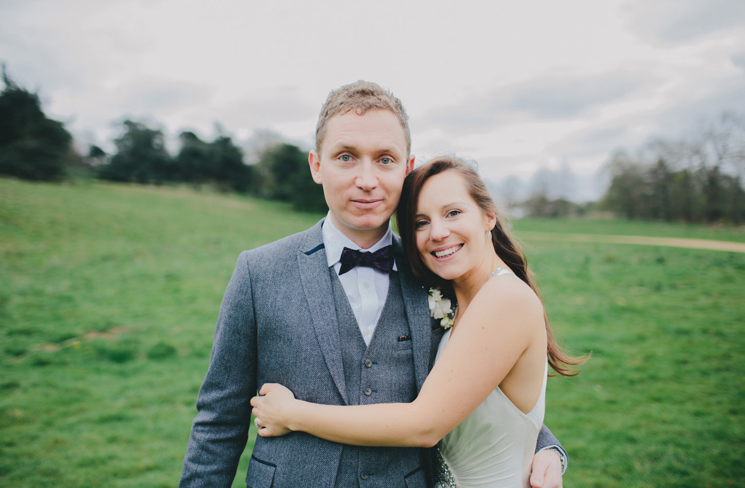 bride and groom in field by Tori Hancock Photography