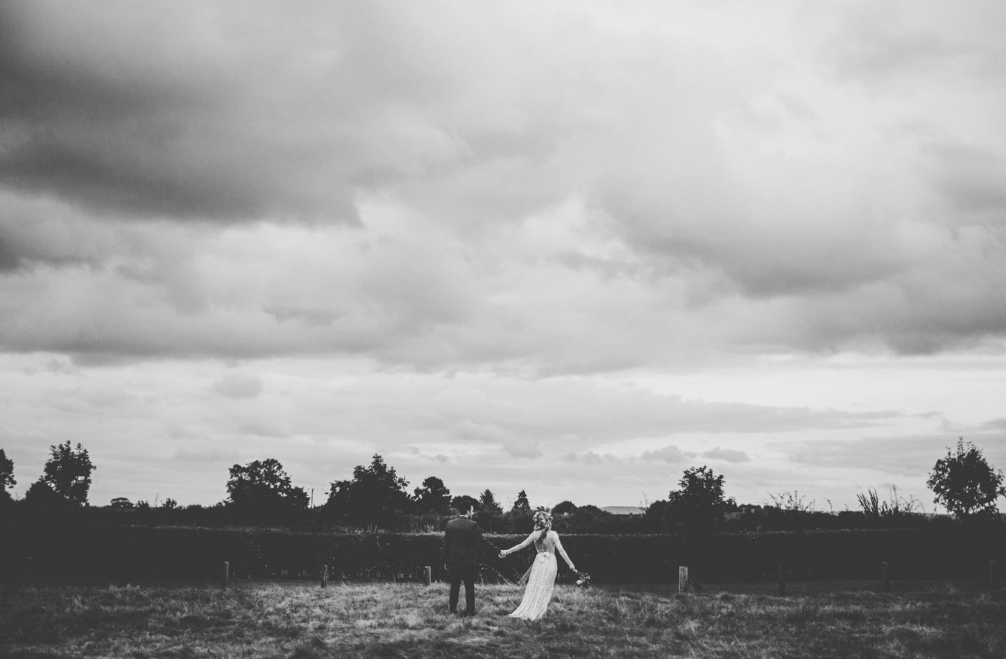 bride and groom in field by Tori Hancock Photography
